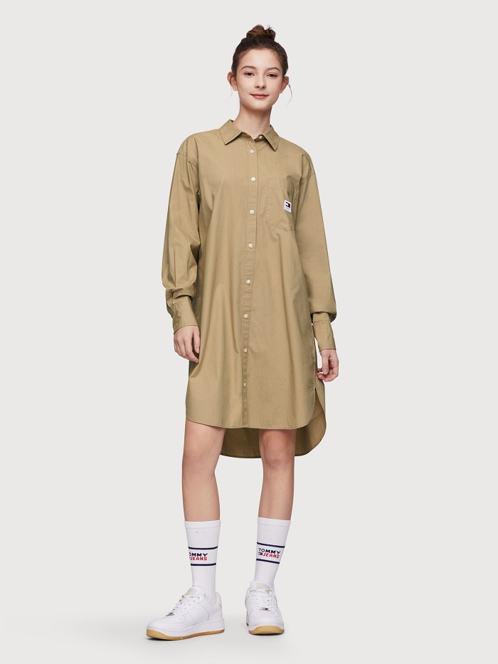 Woman in khaki shirt dress with sneakers